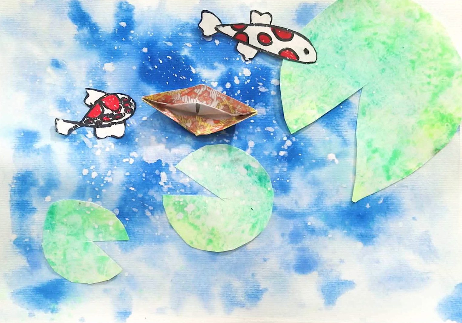 Two cut-paper koi and an origami boat drifting between green lily pads on a splattered blue watercolour pond