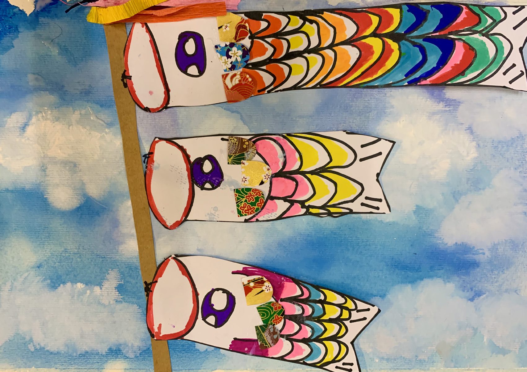Koinobori carp streamers in washi collage over a watercolour sky, Ages 4–5