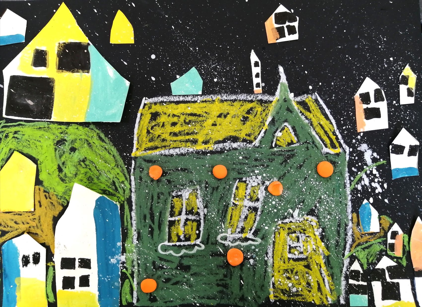 Snowy night town on black paper — a big oil-pastel house ringed by cut-paper houses and orange clay dots