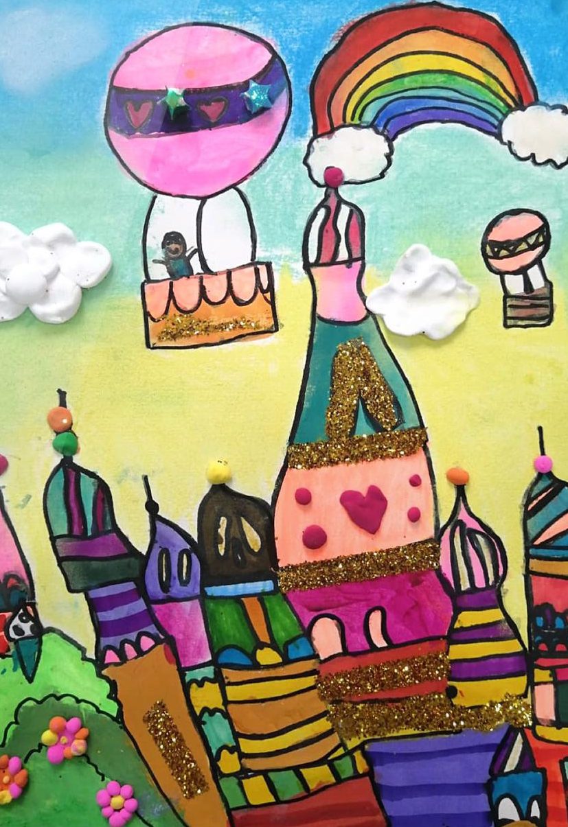 Russian castle with sequinned onion domes beneath a rainbow and hot-air balloons