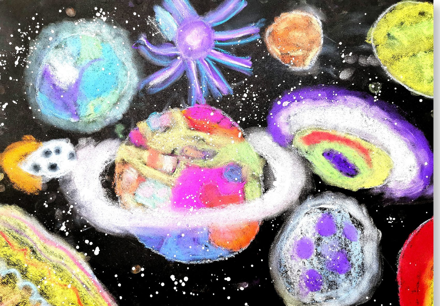 Soft pastel drawing of glowing ringed planets on black paper