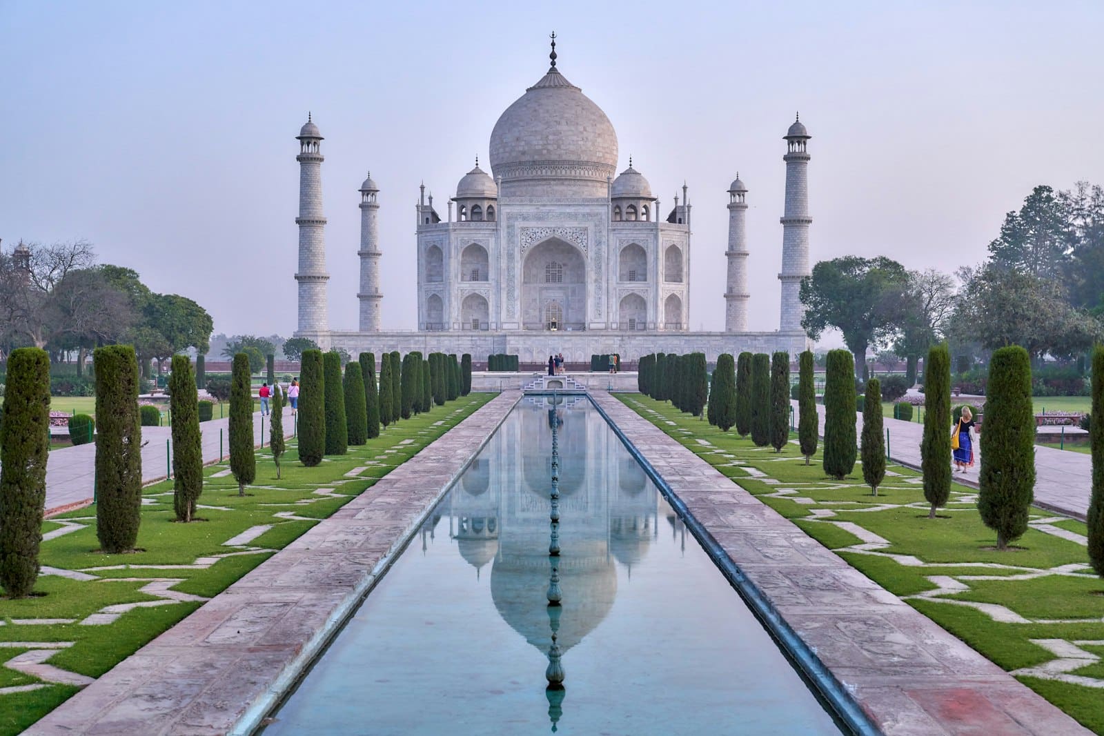 The Taj Mahal at dawn along its reflecting pool