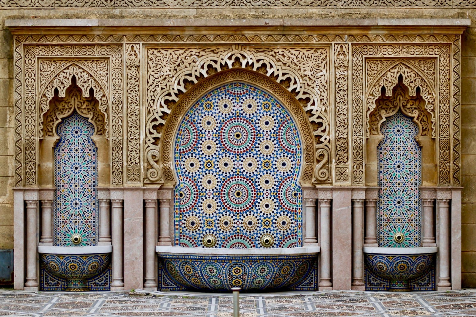 An ornate mosaic fountain in a Moroccan medina