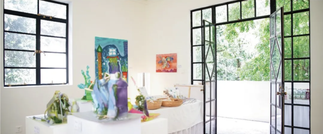 Children's artworks arranged in a bright exhibition space