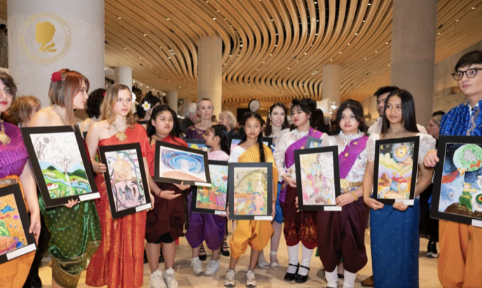 Young artists displaying their works with exhibition guests