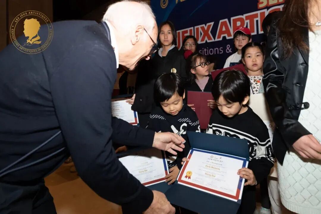 An exhibition guest congratulating a young artist