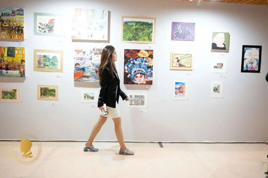 Visitors exploring a gallery of young artists' works